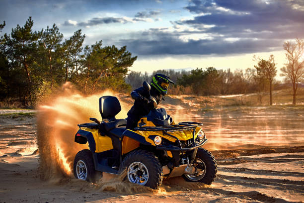 istock Racing powerful quad bike on the difficult sand in the summer. 1202771319