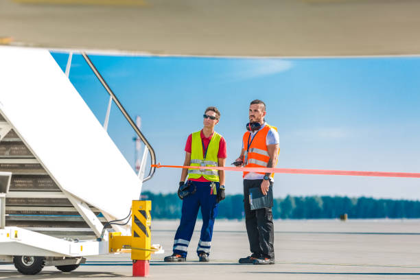 istock Airport service crew next to the airplane 1202772683