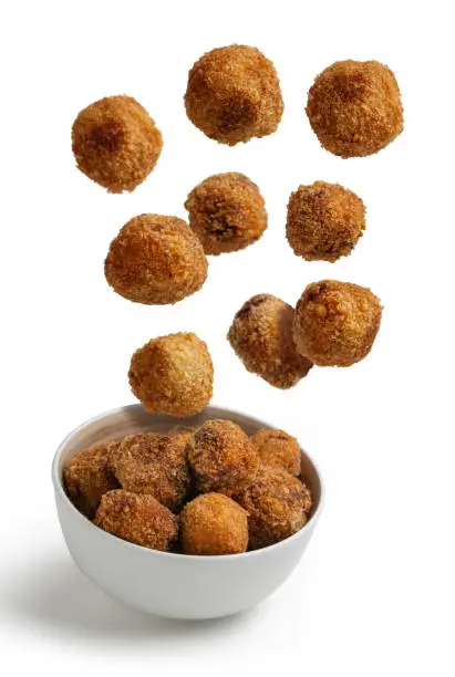 Homemade croquettes flying isolated from white background