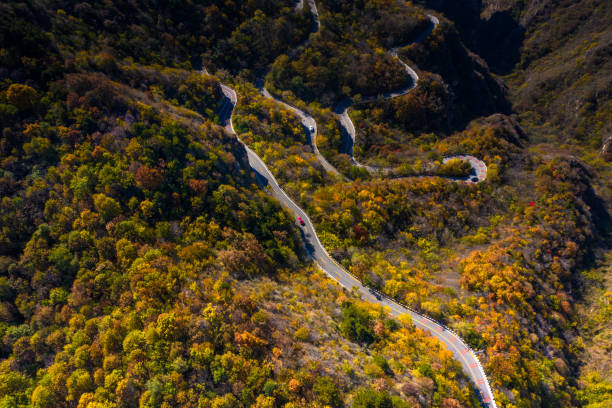 istock Aerial view of empty road going along mountain stream 1202776321