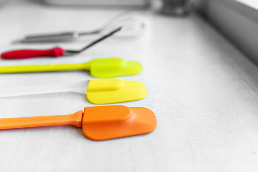 Set of multi-colored silicone spatulas, kitchen tools. Sweet pastries, recipes, cooking.