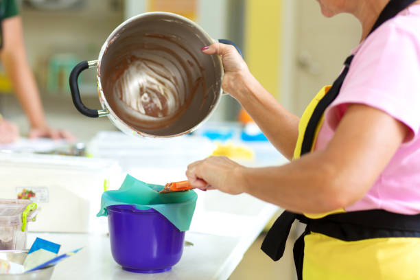 woman professional pastry chef prepares chocolate dough. - chef cookie dishware domestic kitchen imagens e fotografias de stock