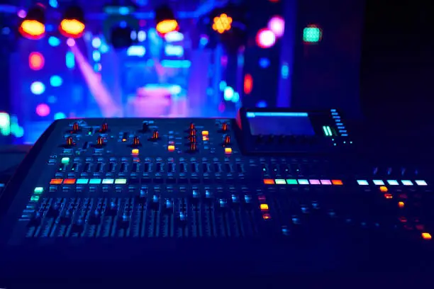 Photo of DJ work at a nightclub, Music club party, Concert equipment, a mixer and DJ console. The concept of disco, entertainment, holiday. Soft focus picture