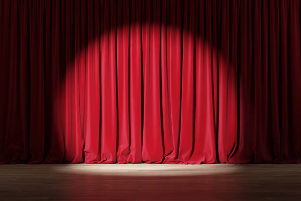 istock Red curtain or drapes in theater with colored lighting. 1202778961