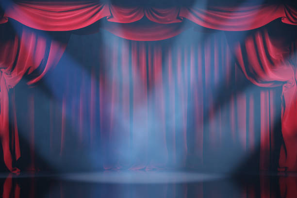 istock Theater stage with red velvet curtains and volume light. 1202779166