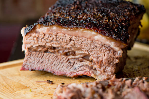 Beef Brisket, classic Texas smokehouse BBQ Beef Brisket barbecue Traditional Texas Smoke House . Rubbed with spiced & slow smoked in a classic Texas smoke house over mesquite wood chips in traditional classic BBQ method. Chopped Beef Brisket. brisket photos stock pictures, royalty-free photos & images