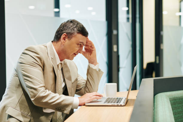istock Tired Bussinessman Working On Laptop 1202780042