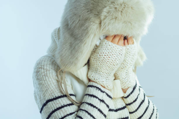 istock sad woman crying isolated on winter light blue background 1202783982