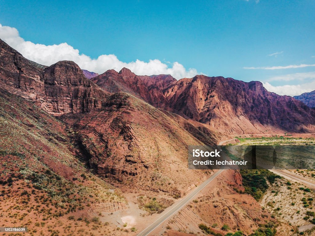 Aerial view on the red rocky mountains of Argentina A scenic view from above on the red rocky region of the Andes mountains in Salta, Argentina. Salta - City Stock Photo