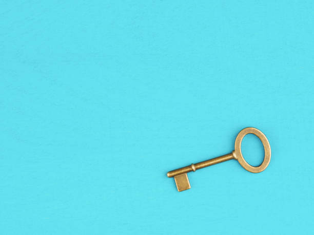 istock Old bronze antique key on blue wooden background with copy space 1202786774