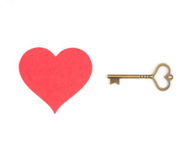 Image of a heart and a vintage key isolated on a white. Love relationship concept Image of a heart and a vintage key isolated on a white. Love relationship concept wellhead stock pictures, royalty-free photos & images