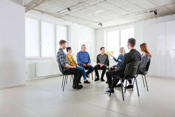 istock Men and women discussing problems in lecture hall 1202786993