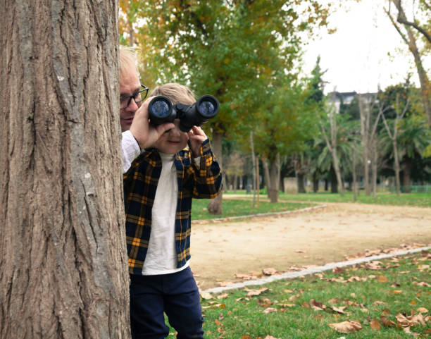 istock Dad and son looking the birds with binoculars 1202789331