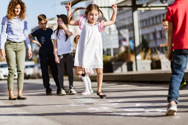 istock Children playing hopscotch on playground 1202789439