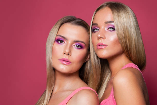 istock Perfect women faces. Pink lips, eyeshadow makeup on pink background 1202789443