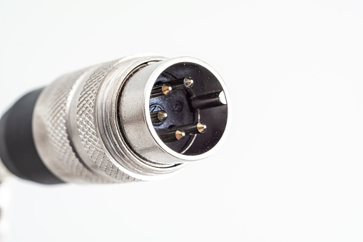 XLR din plug connector close up shot with visible connection pins isolated on white