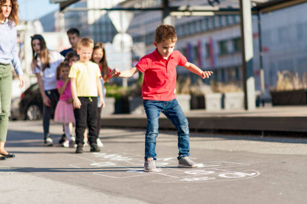 istock Children playing hopscotch on playground 1202790502