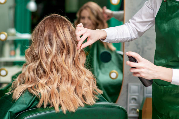 istock Hairdresser makes hairstyle. 1202791069