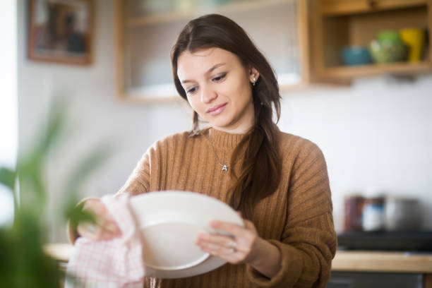 istock young woman baking cookies in the kitchen 1202791179