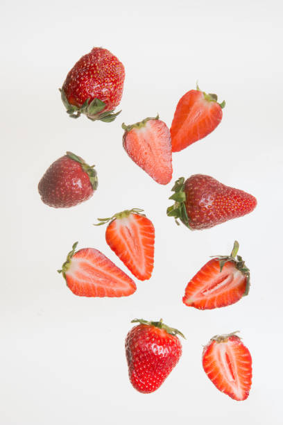 istock Slices of fresh strawberries on white background 1202791383