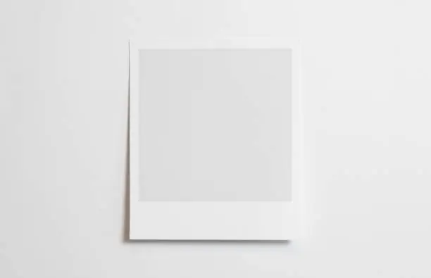 Blank polaroid photo frame with soft shadows isolated on white paper background as template for graphic designers presentations, portfolios etc.