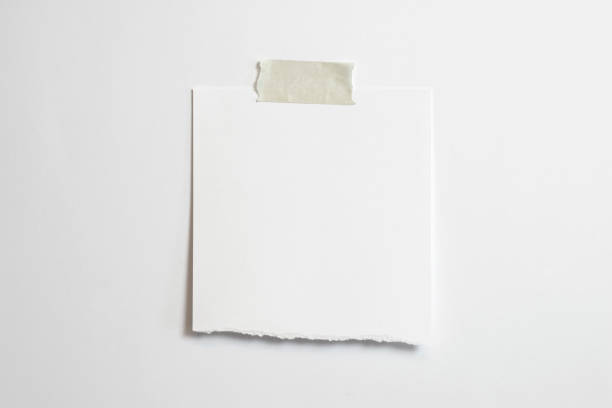 istock Blank torn polaroid photo frame with soft shadows and scotch tape isolated on white paper background as template for graphic designers presentations, portfolios etc. 1202792194