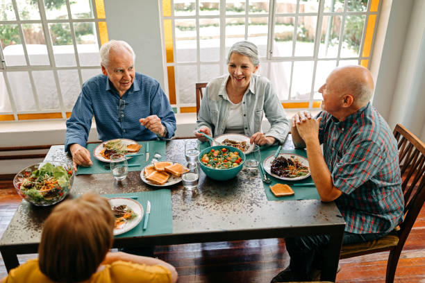 istock Happy senior people having breakfast in nursing home 1202793799