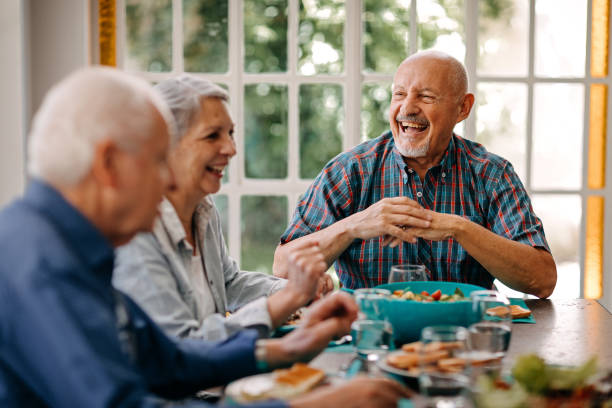Happy senior people having lunch in nursing home
