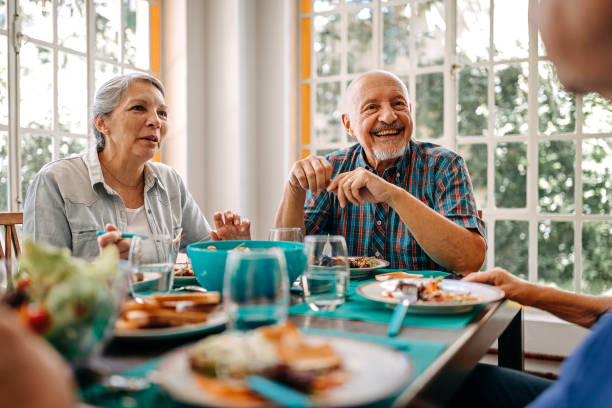 istock Happy senior people having breakfast in nursing home 1202793889