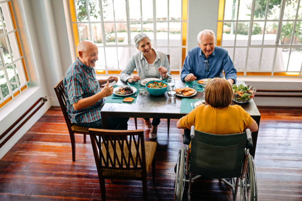istock Happy senior people having breakfast in nursing home 1202793940