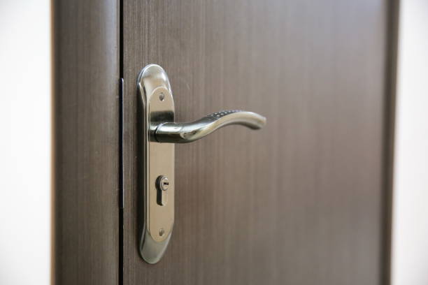 istock dark handle on the brown door 1202794213