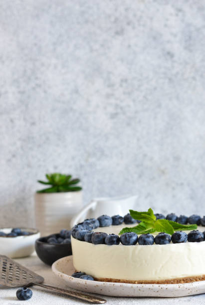 istock Classic blueberry cheesecake on the kitchen table. Concrete background. 1202794240