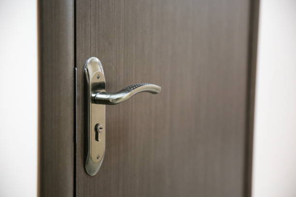 istock dark handle on the brown door 1202794373