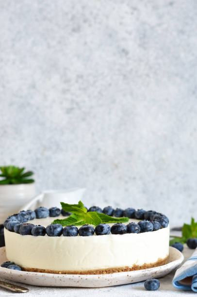 istock Classic blueberry cheesecake on the kitchen table. Concrete background. 1202794383
