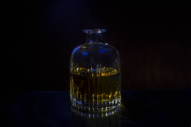 istock Decanter with whisky black background blue light 1202794557