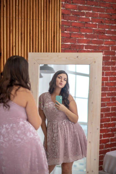 istock Young plus-size woman making selfie and feeling positive 1202795211