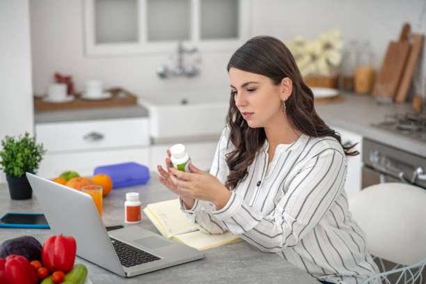 istock Dark-haired woman in a striped blouse looking interested 1202795459