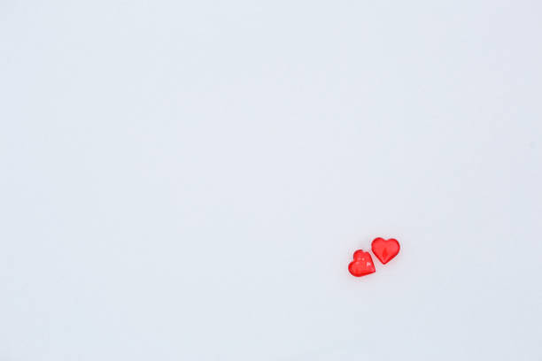 istock Red glass hearts on the snow. 1202795758