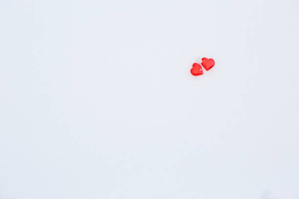 istock Red glass hearts on the snow. 1202795762