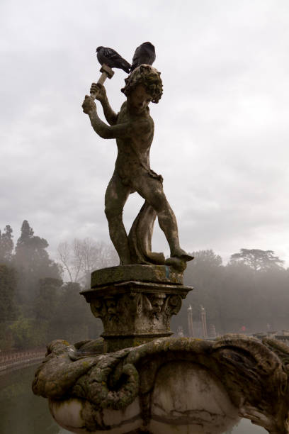 Florence, Italy - December 30, 2009: Statue in Giardini di Boboli. A late16th - 18thth century statue in slowly decays the famous Giardini di Boboli is adorned with Pigeons.