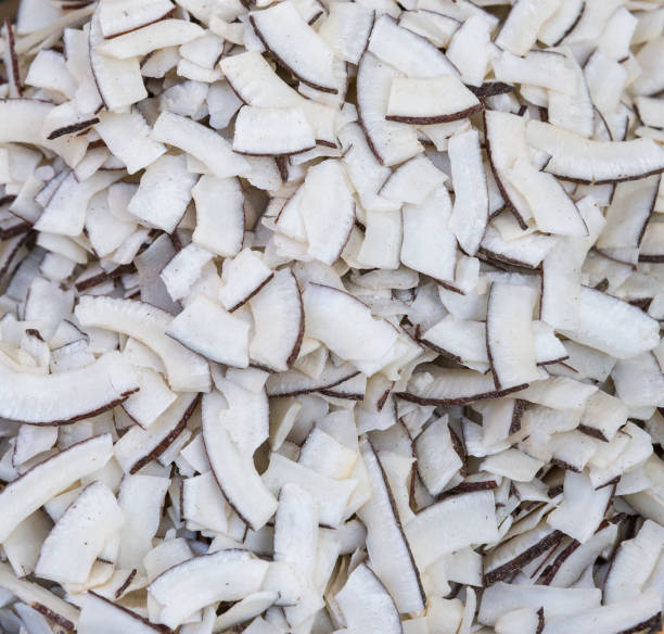istock Roasted baked toasted Natural Thin Sliced Coconut Chips Background texture 1202797871