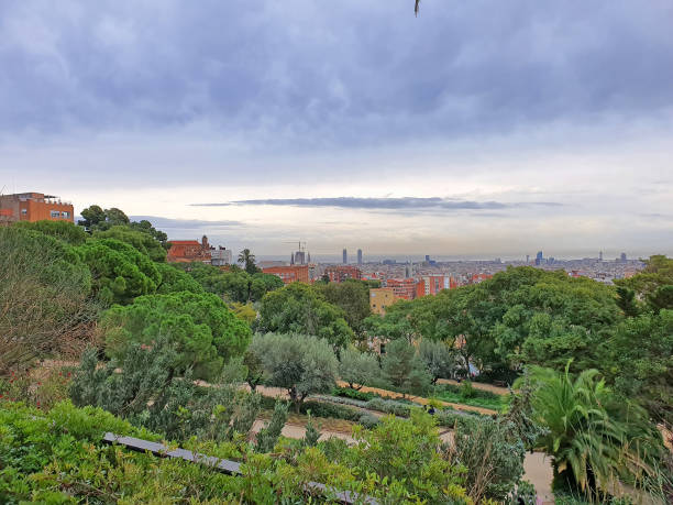 Fascinating view on magnificent city to blue sea from Guell park in Barcelona. Nature and urban compatibility concept.