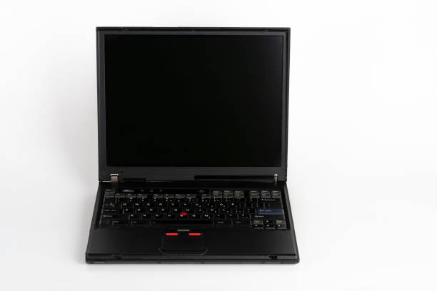 istock Old laptop on white background, which was produced in 2003, diagonal screen size 14 inches, outer cover reinforced titanium, metal hinges, red trackpoint. 1202799321