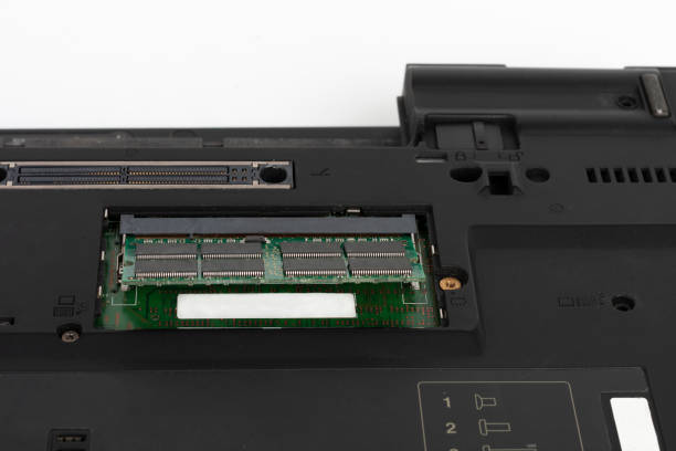 istock Replacing of ram memory in laptop computer. Underside of the notebook on white. 1202799821