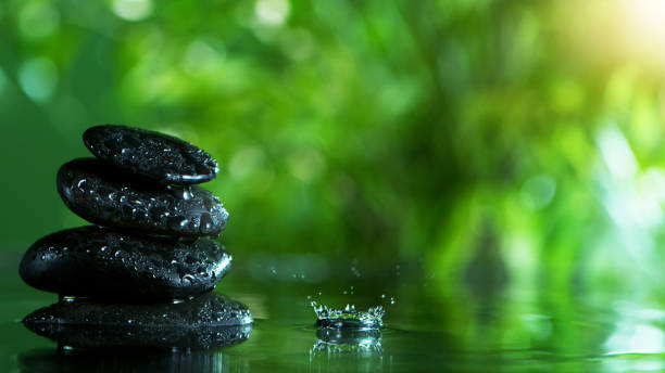 istock Dripping drops of water with black lava stones 1202800015