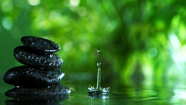 istock Dripping drops of water with black lava stones 1202800023