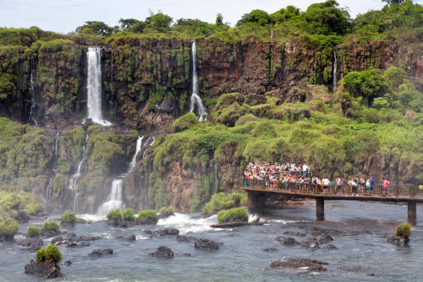 Argentina Iguazu Waterfalls with Visitors Tourists admiring one of New Seven Wonders of Nature, the Iguazu Falls in Argentina. misiones province stock pictures, royalty-free photos & images