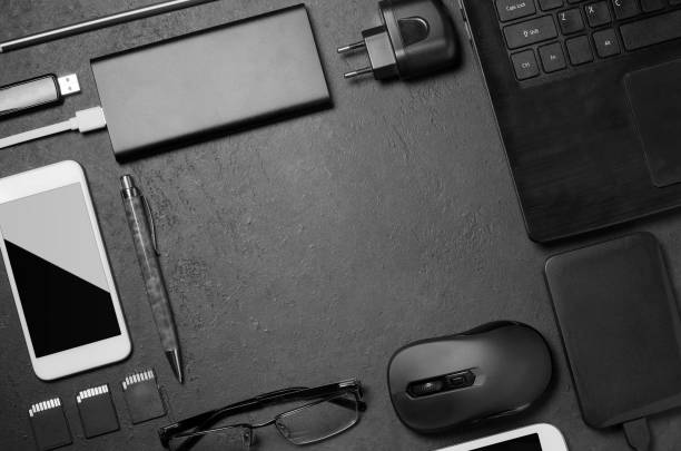 istock Electronic gadgets on a black concrete background. Concept of accessories for successful business. Flat lay. 1202805758