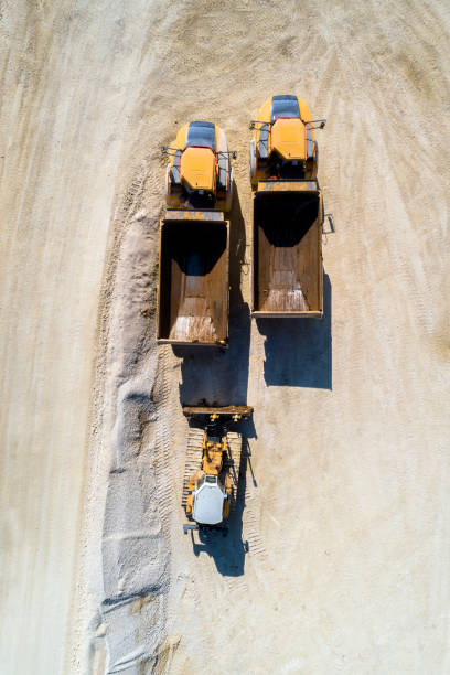 istock Dump Trucks and Bulldozer in a Quarry, Aerial View 1202806857