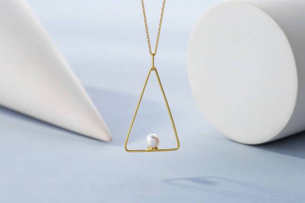 istock Triangle shape gold pendant necklace with pearl 1202808660